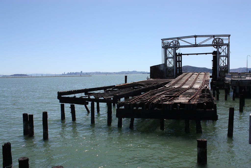 Ferry landing with San Francisco and Bay Bridge on horizon by Pye