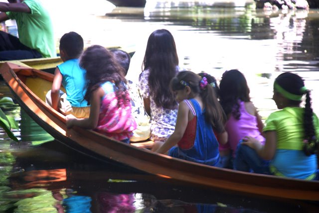 Children in a boat, inside an Amazon Park by Carlos Barretto