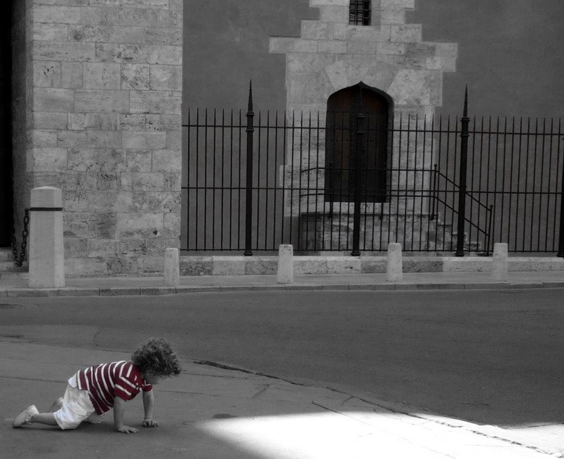 Red shirt down in front of the old gates of Valencia by themistius