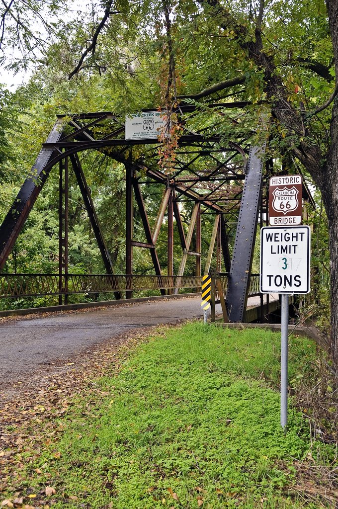 The 1926 iron girder bridge over Pryor Creek near Chelsea, Oklahoma. This portion of route 66 was vacated when the dual highway section was opened. by Fred Henstridge