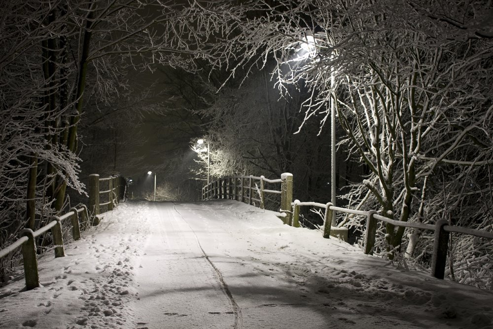 Old railway bridge covered in snow. by Hideout.dk