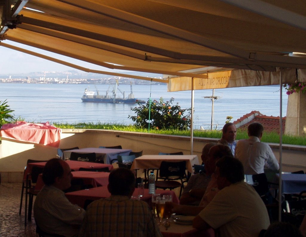 Cafe overlooking river in Lisbon by Jim Mansfield