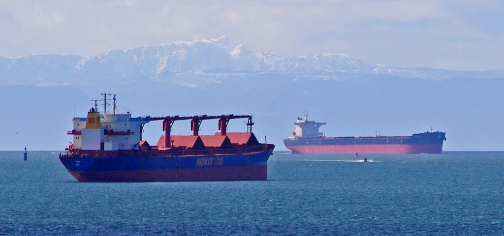 Freighter traffic in English Bay. Mount Arrowsmith, Vancouver Island, In the background. from Stanley Park. (Looking West) by Marcel Pepin