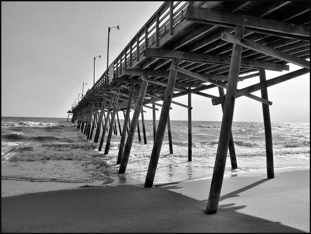 Boque Fishing Pier in late afternoon sun by kevin childress' b-and-w