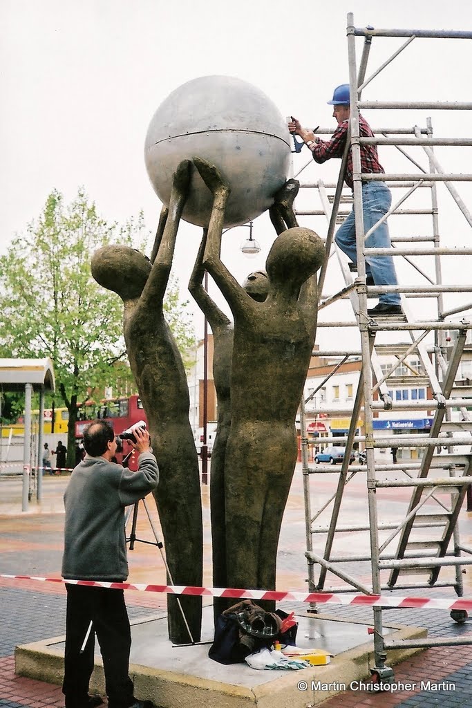 Rivetting top half of globe into position. by keybords