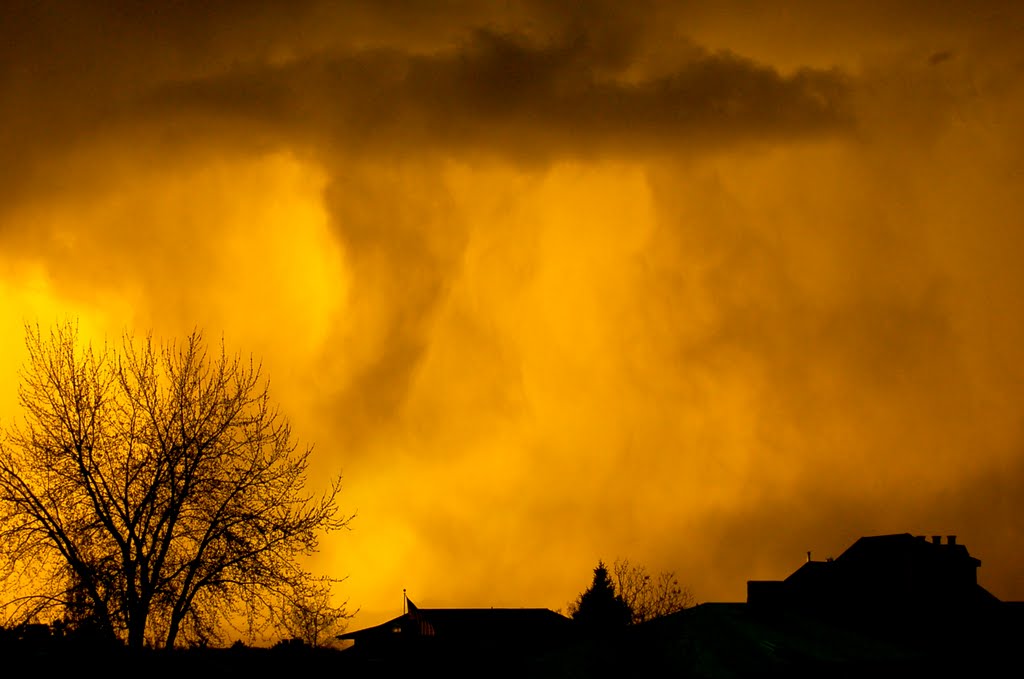 Golden sun set with rain clouds by Jed Fackrell