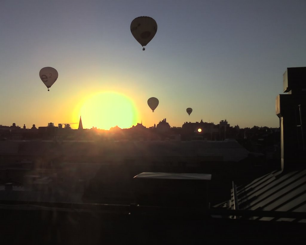 Sunset with balloons viewed from a roof by isakth