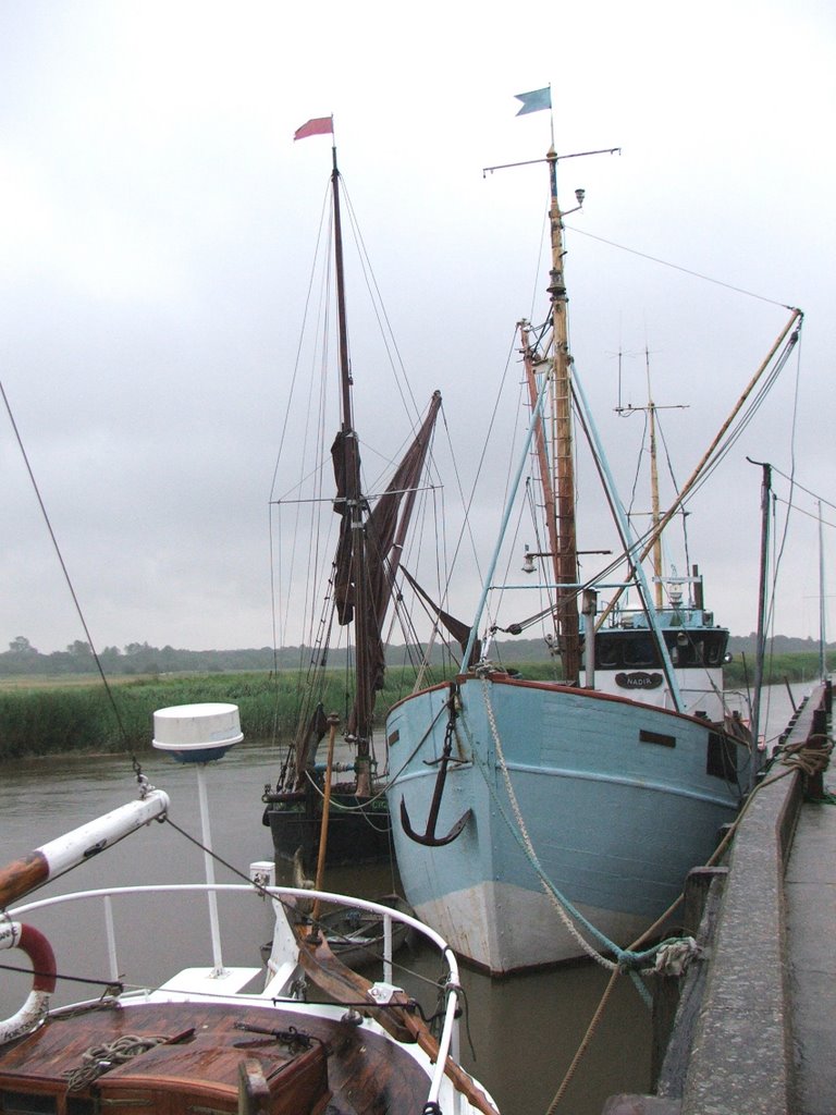 Boats moored on the River Alde at Snape Maltings by John Goodall