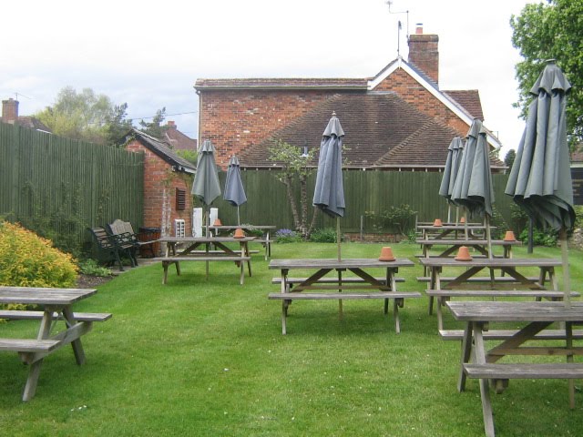 The sets of wooden tables, with dark green parasols by Robert'sGoogleEarthPictures