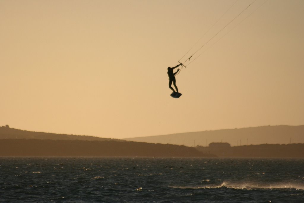 Kite surfer doing a jump at sunset by tomlessing