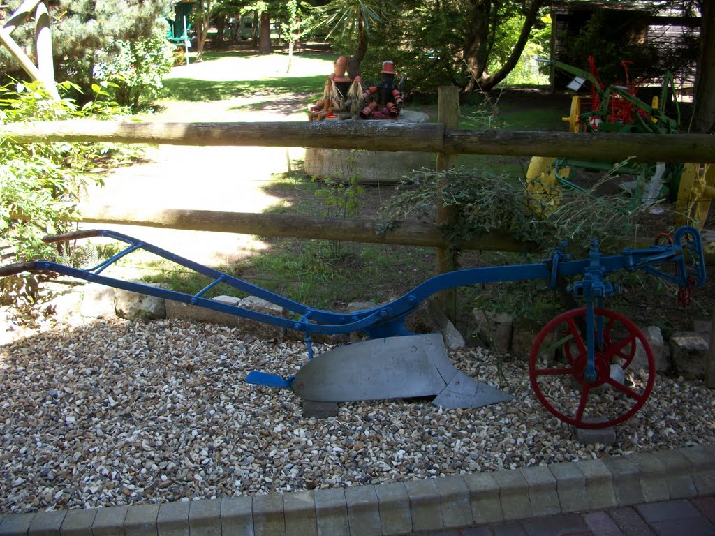 The blue farm machinery, with red wheels by Robert'sGoogleEarthPictures