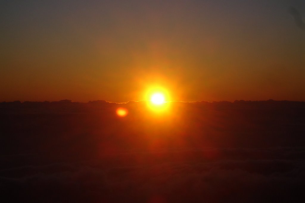 Sun rising over clouds from Haleakala by ldeano