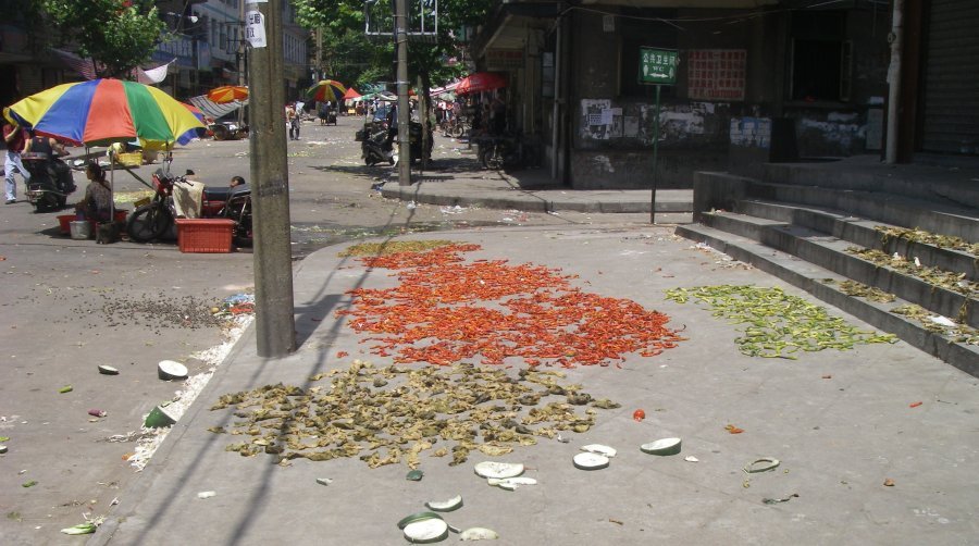 Drying chillis and vegetables on the street. by justin.robinson.cook