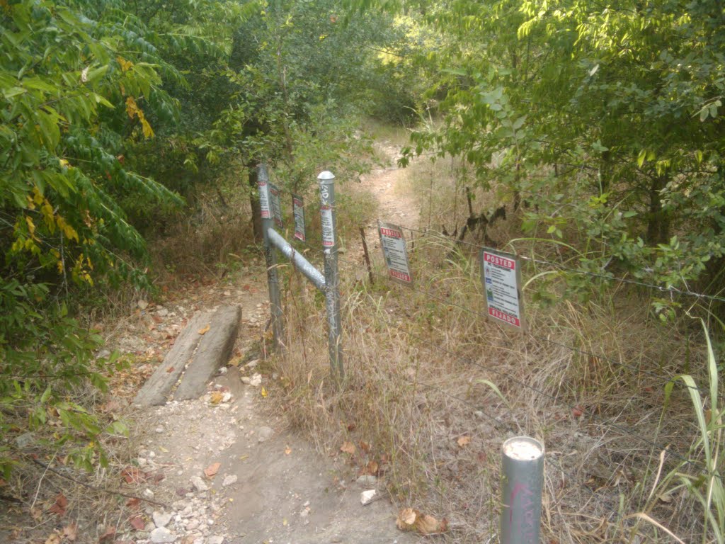 In spite of the barbed wire, you can just walk through, and apparently many do by Chris Robison