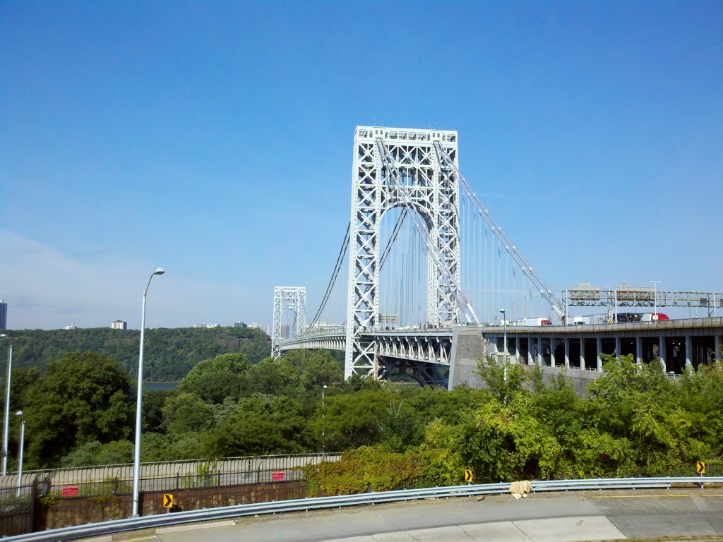 The George Washington Bridge from Manhattan, you can see the 8 lanes of traffic on the top deck and 6 lanes of traffic on the lower deck. by Jeremy Melville