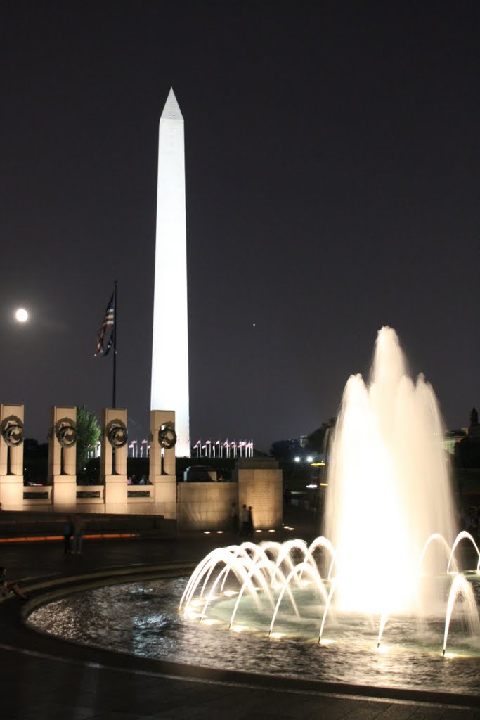 The World War II Memorial with the United States Capitol and Washington Monument in the Background at Night with the Moon in the Background by skibum415