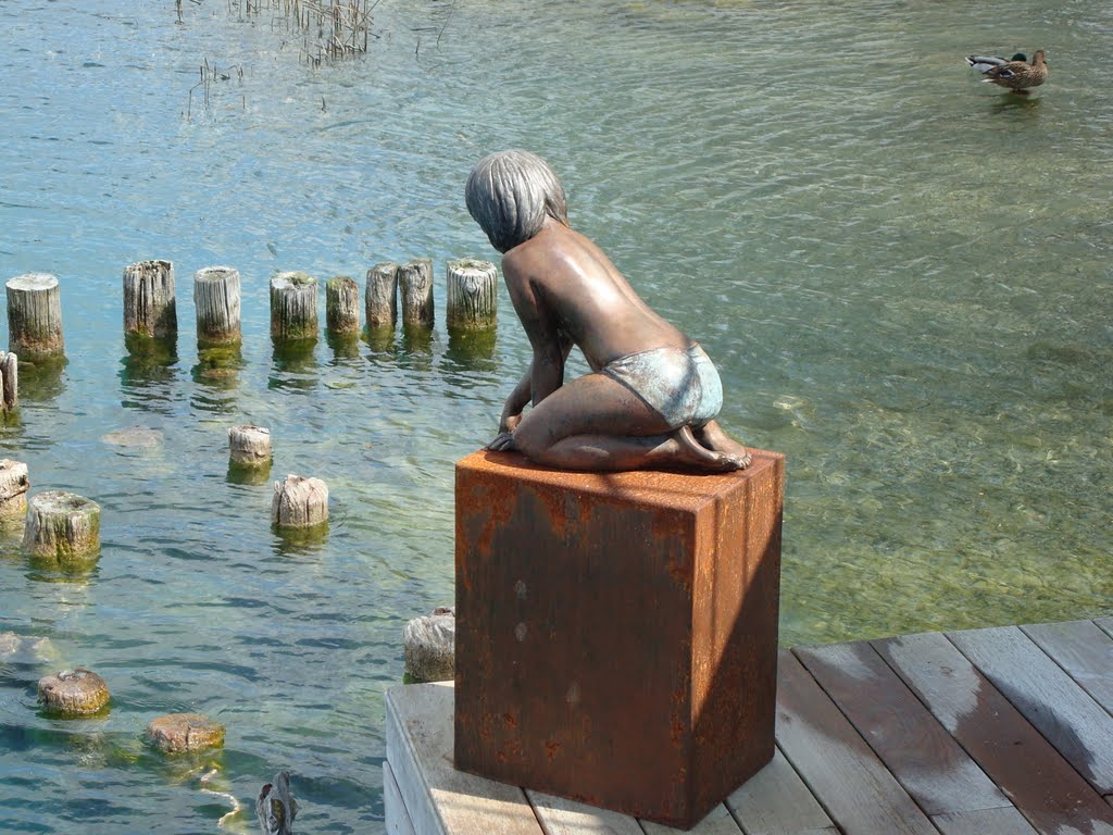 Child looking for a fish by paul eichenberger