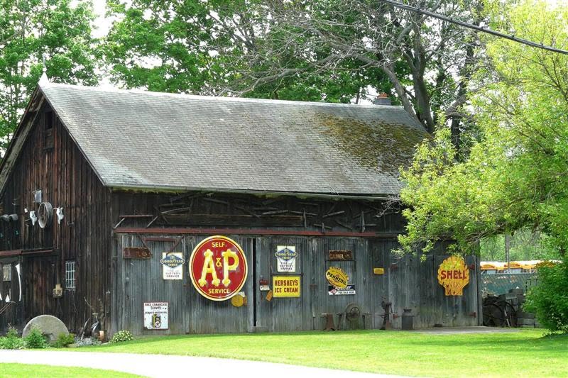 Old metal signs on barn (america picker) by Geraldine Clark