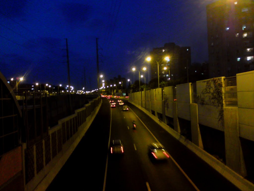 Ayalon highway at night. by Oz Lev