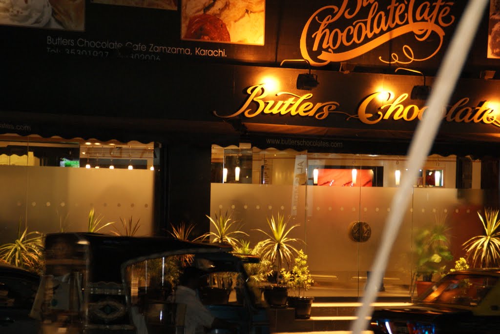 A NIGHT VIEW OF BUTLERS CHOCOLATE CAFE ZAMZAMA STREET KARACHI SINDH by Mir Meharullah Talpur