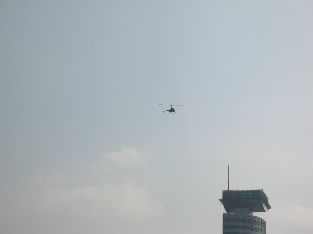 Hovering over the broadcast center of a small helicopter 盘旋在廣播中心上空的一架小型直升飛機 by Wencheng Yan