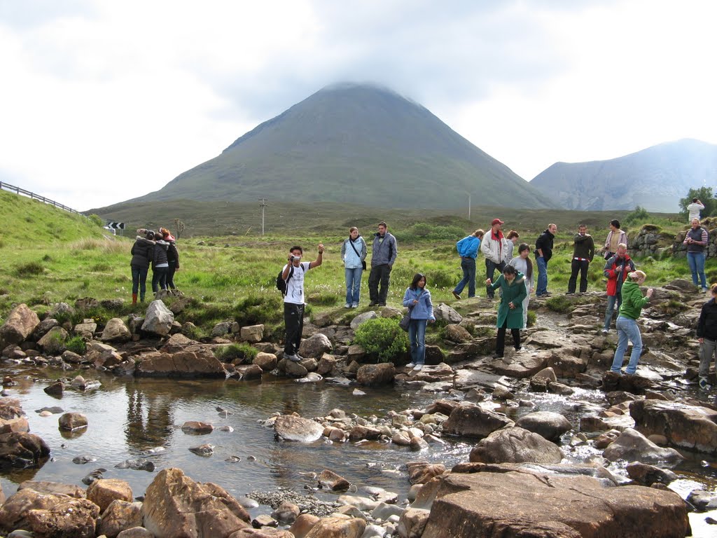 May 2008 - Skye, Highland, Scotland. Tour group at the River Sligachan with the peak of Glamaig (Greedy Woman) rising behind. by BRIAN ZINNEL