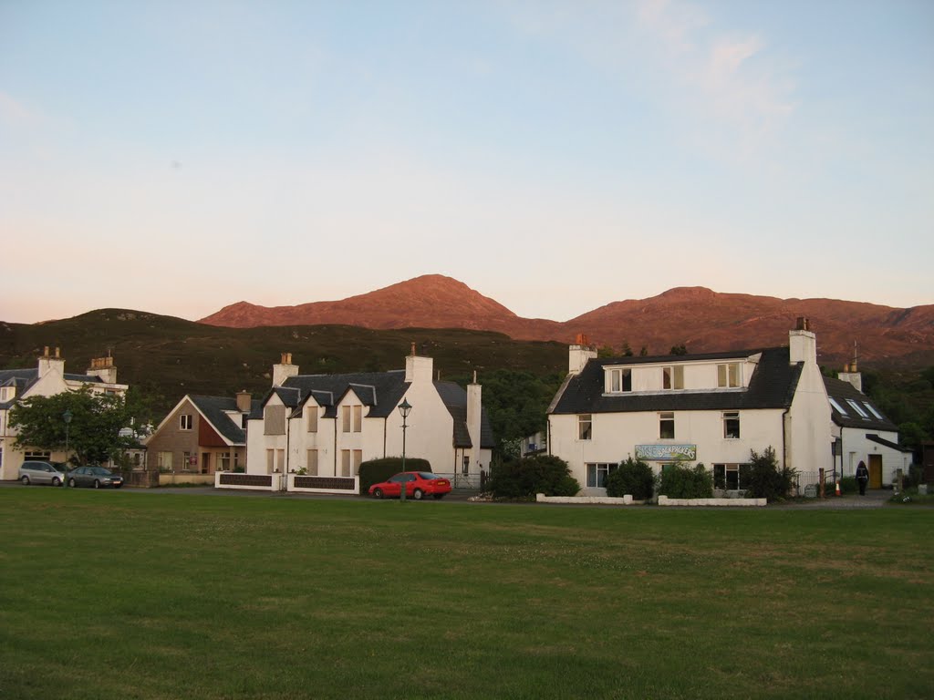 May 2008 - Skye, Highland, Scotland. The hills of Skye glowing red beyond the village of Kyleakin. by BRIAN ZINNEL