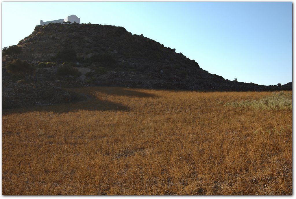 A field and church in Tripiti. Milos island. Greece by stergios gitopoulos