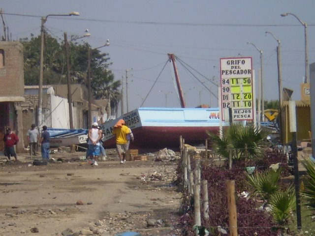 Stranded boats on coastal road in front of artisanal fishermen's gas station of San Andrés, 18h post tsunami by Ricardo Bandin Llanos