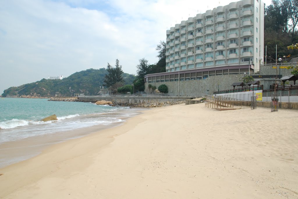 The famed nipple rock (in water) and the Warwick Hotel Cheung Chau. The flags atop the hotel were very tatty. by David K