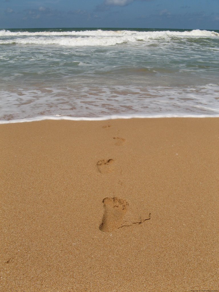 Footprints at the beach by Charith Mallawaarachchi