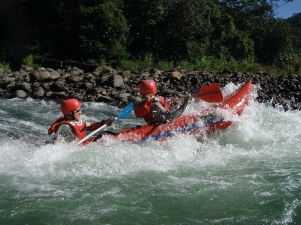 Hold on! Kayaking the rapids by GreenFrogAdventures