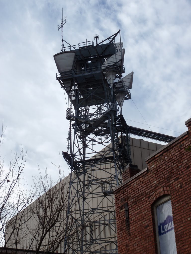 The tall antenna tower behind the AT&T facility in downtown Raleigh, complete with seashell-like microwave antennae, but no longer in use, 1-22-11 by tompope2001