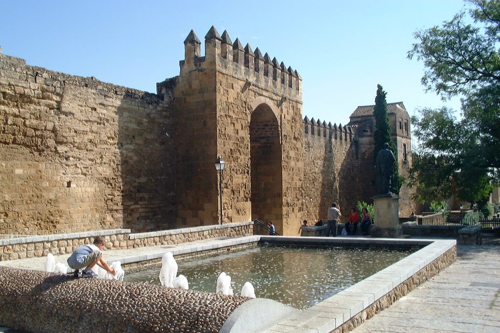 Child playing in fountain at Puerta de Almovodar, Cordoba by John Goodall