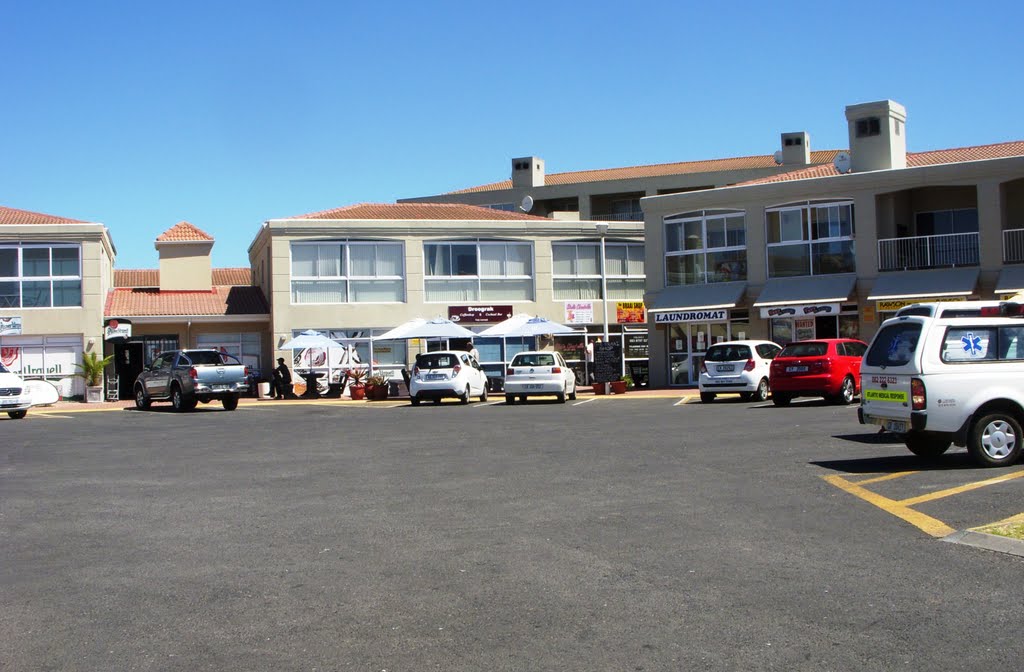 Laundromat and shops by Charles Vrey