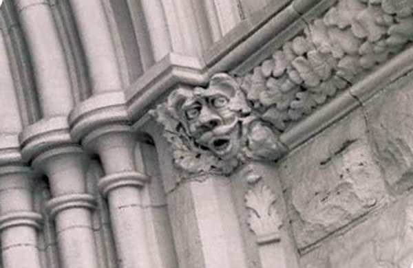 Grotesque faces by the door by nailhed.com