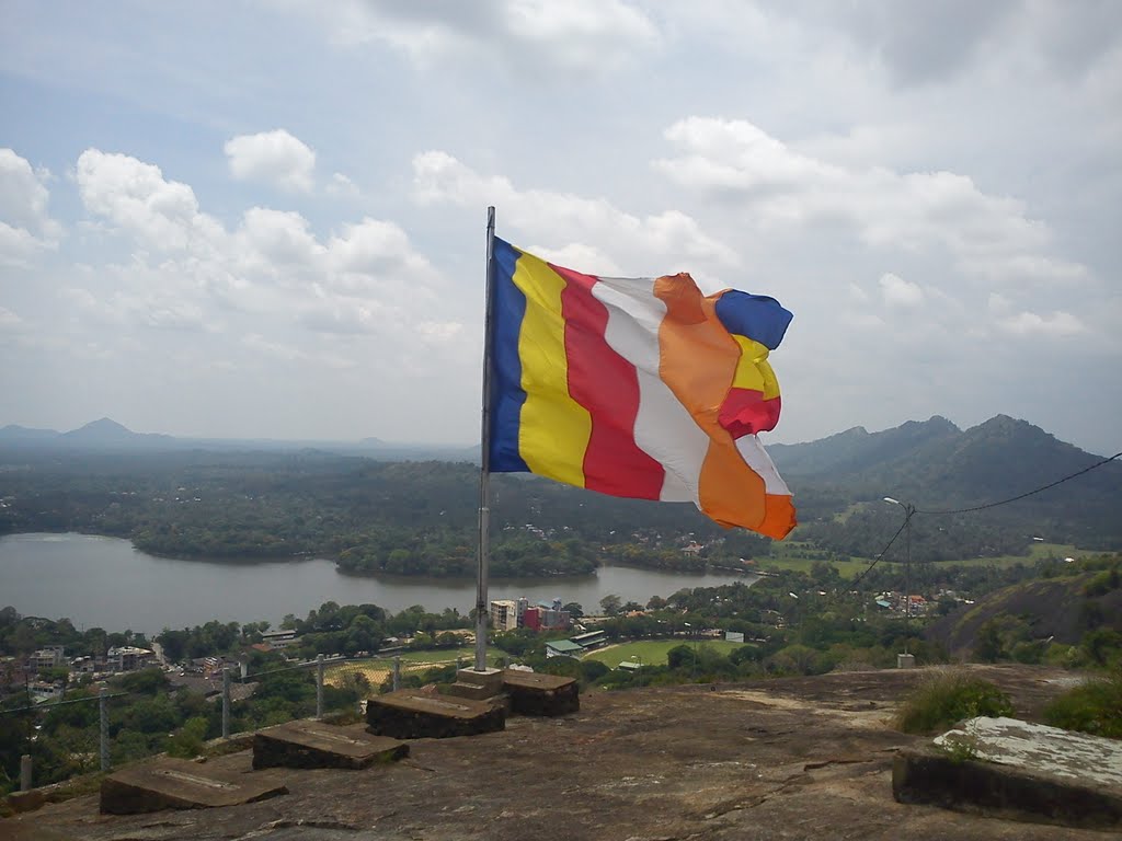 Buddhist Flag on top of Athugala Rock by Jagath Abesekara