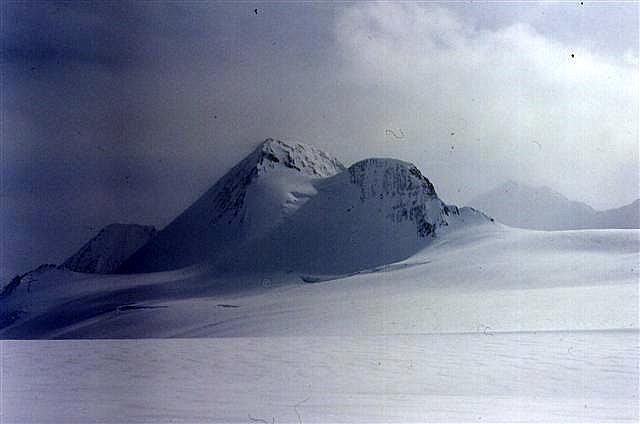 Mount Columbia in the Columbian Icefields being approached by ski mountaineers for a winter ascent. by HowardCampbell