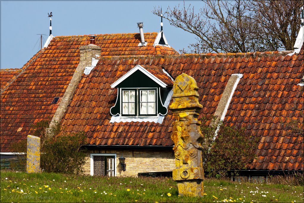 Tombstone and farmhouse, Terschelling, The Netherlands by Wim Janssen