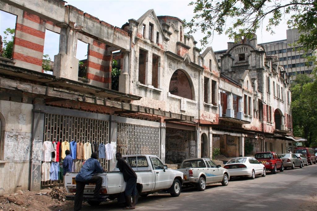 Street vendors on a derelict building by Ian Donald