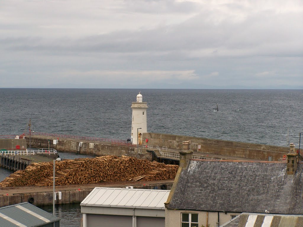 Pit props lying on the quay at Buckie Harbour by Gilbert Smith