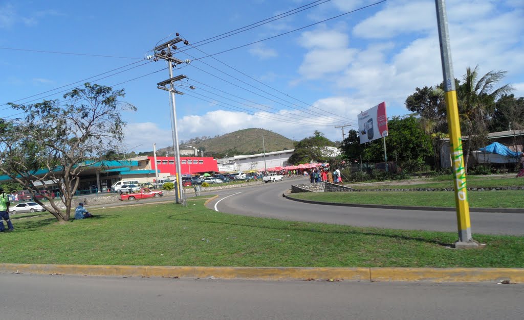 Driving along Taurama Road looking across to InterOil Fuel Station on corner of Gavamani Road Rounderbout, with Malaoro Supermarket behind, on 25-06-2011, Port Moresby, PNG by Peter John Tate,