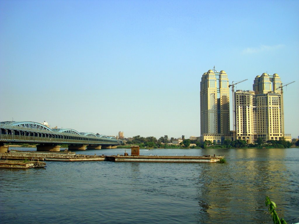 Nile City towers & Imbaba bridge in the afternoon from Imbaba, Giza by Alaeddin Faruki