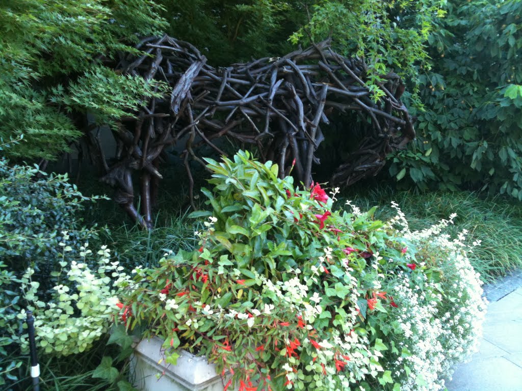 Nice plant arrangement next to a unique bench sculpture by Chick Lam