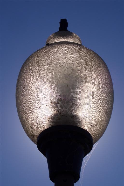 Sun thru lamp, City of Kansas Bridge, Kansas City, MO by Maxine Arnoldy