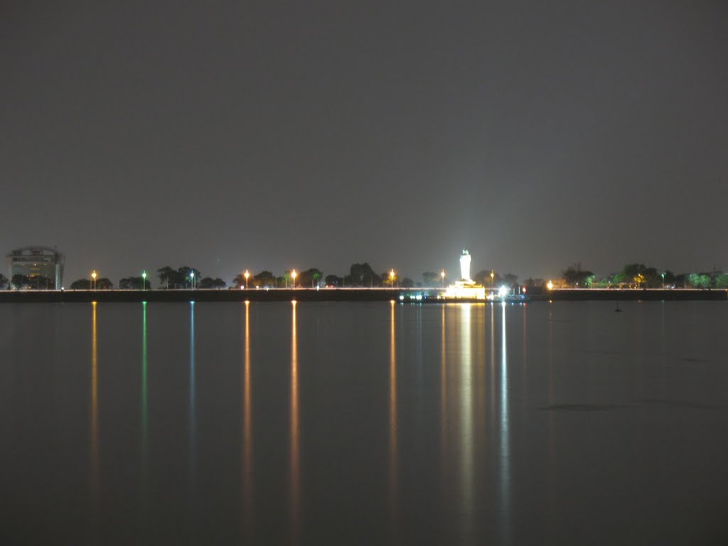 The Buddha statue in the middle of Hussain Sagar at night. by ybnormal78