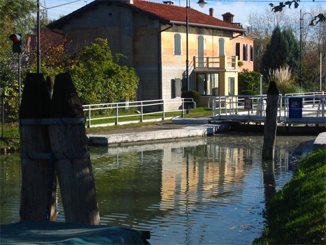 River road to Venice. Moranzani floodgate. by Andrea Pasini