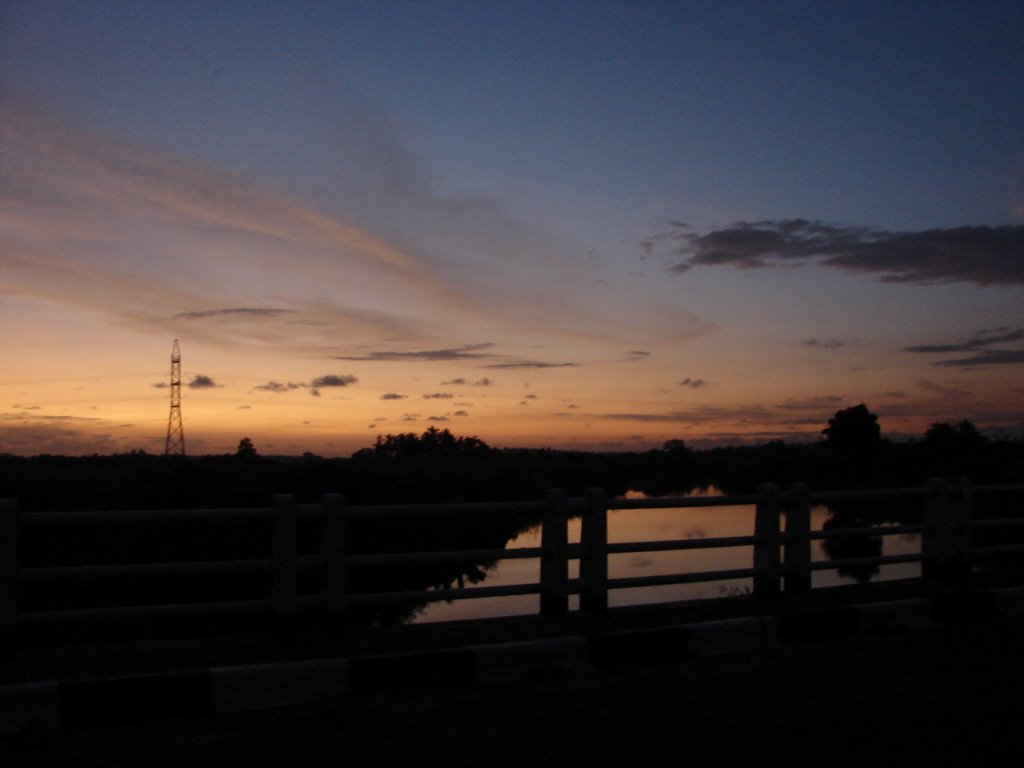 Sunset over the bridge by Buddika Hettitantri