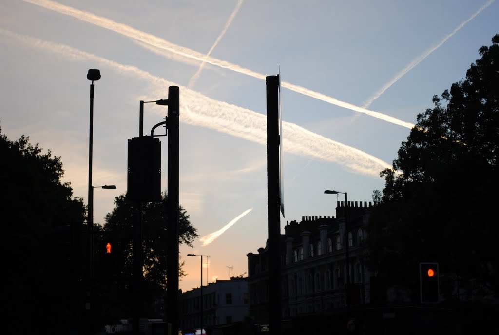 Aircraft trails in the sunset rays on City Road by Alexander Kachkaev