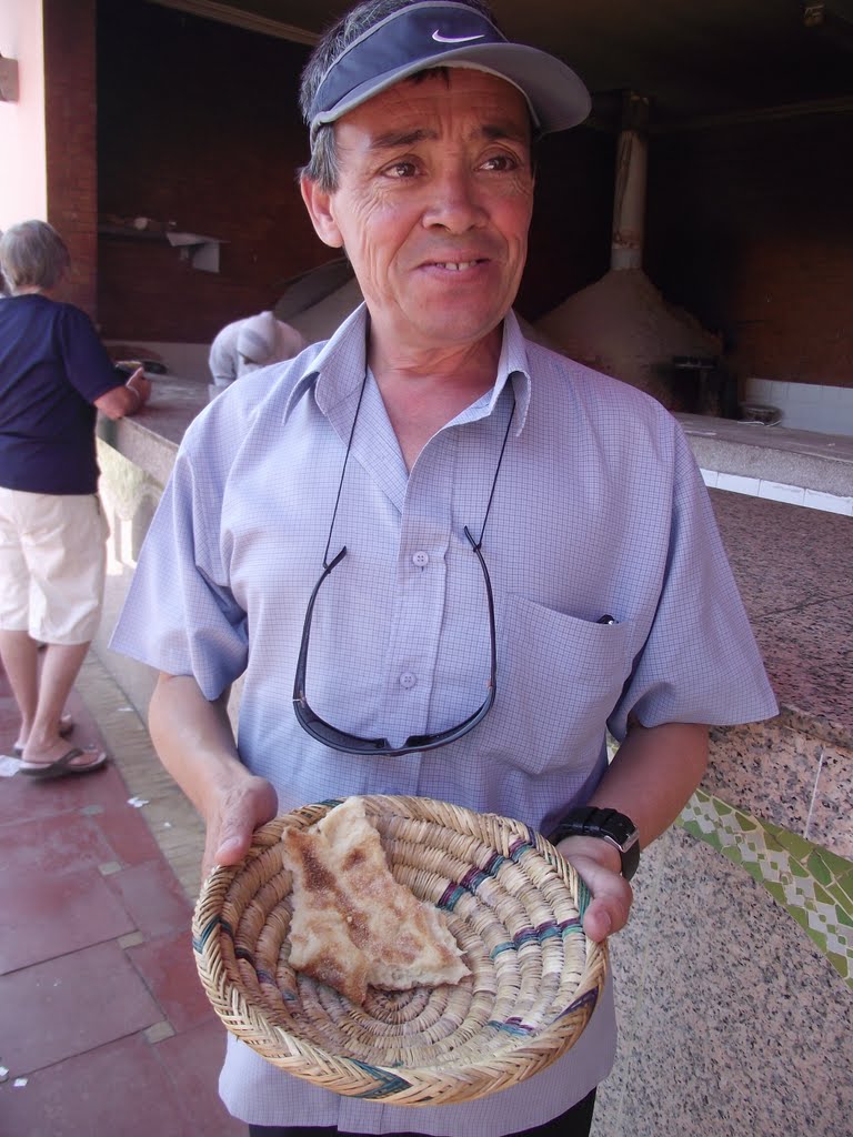 Moroccan tour guide offers traditional bread by loronb